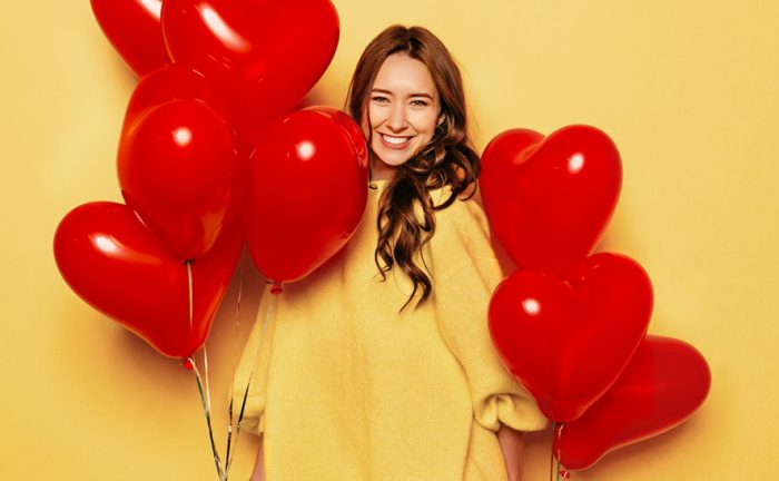 woman with heart-shaped baloons
