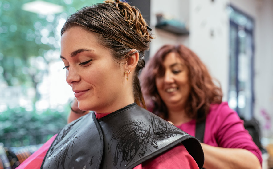 A woman getting hair done